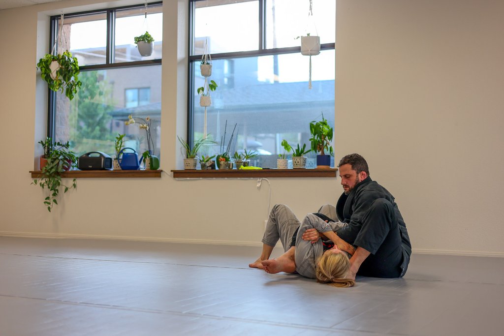 Members training in gi with plants visible at Golden Jiu Jitsu in Golden, Colorado