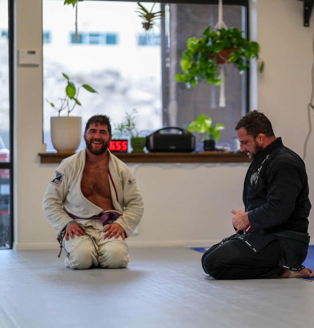 Two members laughing between rounds at Golden Jiu Jitsu