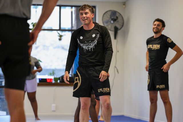 Members laughing together after training at Golden Jiu Jitsu