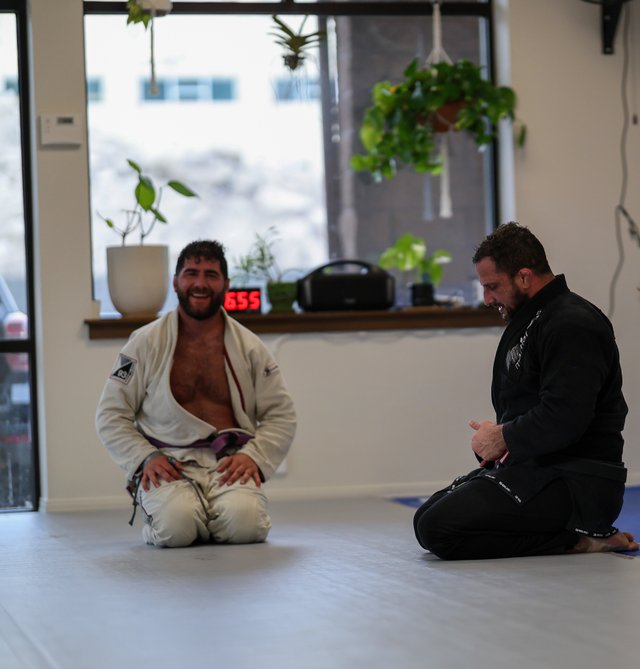 Members smiling together after a training round at Golden Jiu Jitsu