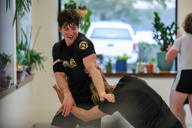 Members laughing between rounds at Golden Jiu Jitsu